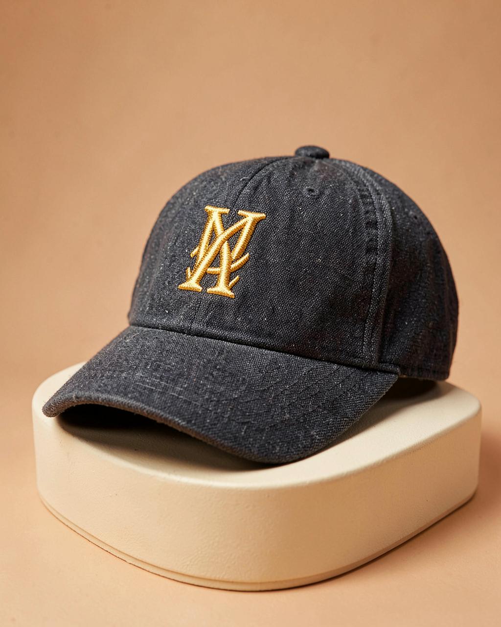 Charcoal structured baseball cap with a gold embroidered monogram
