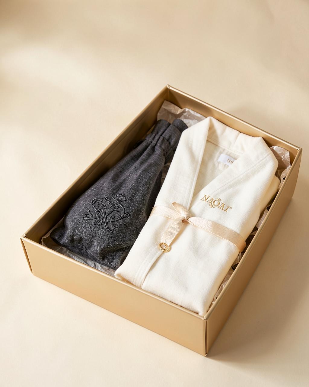 Monogrammed ivory robe and charcoal linen pouch packed in a champagne gift box