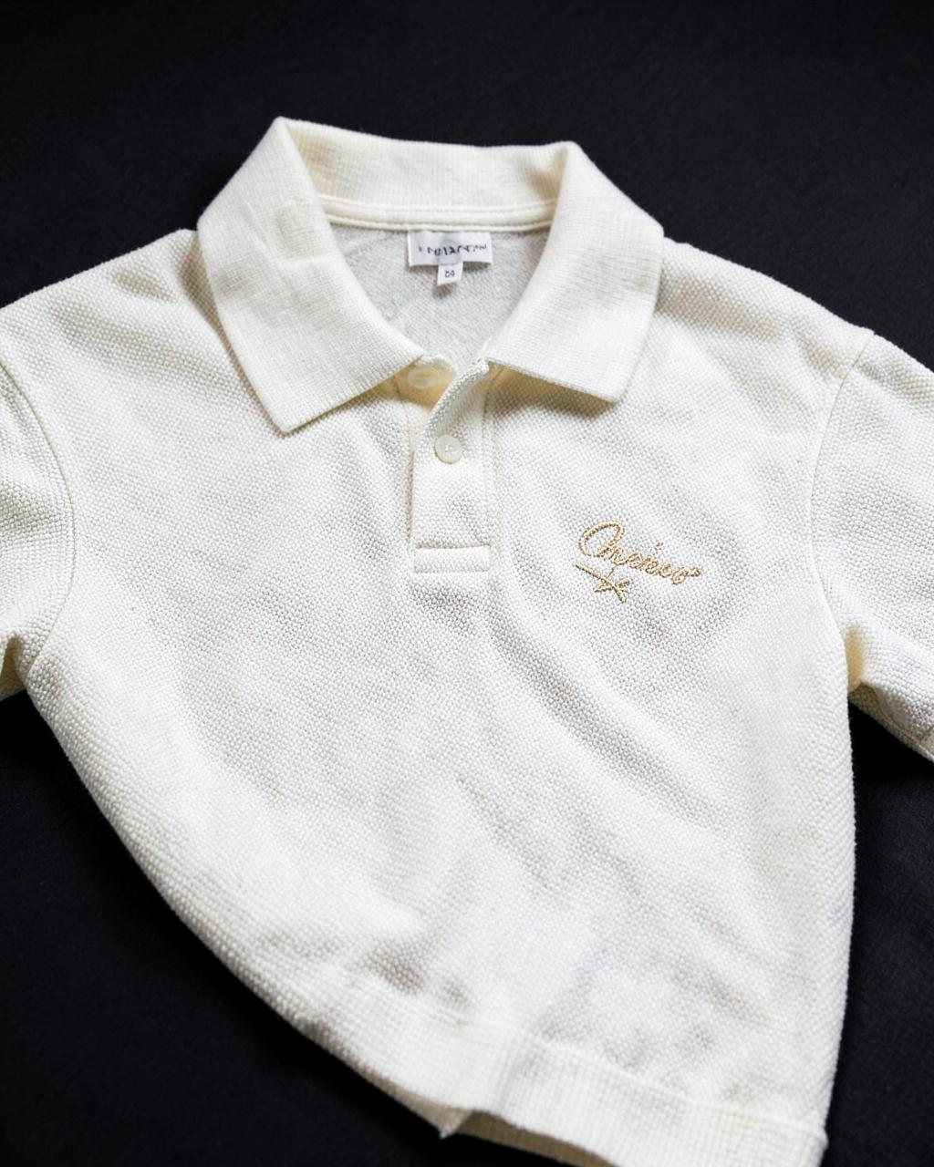 Ivory piqué polo shirt with a champagne embroidered wordmark on the chest